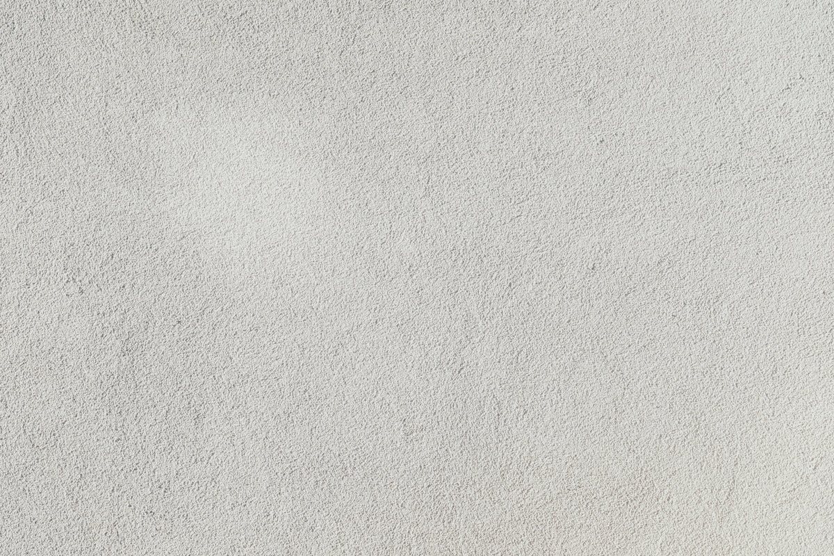a close up of a white stucco wall