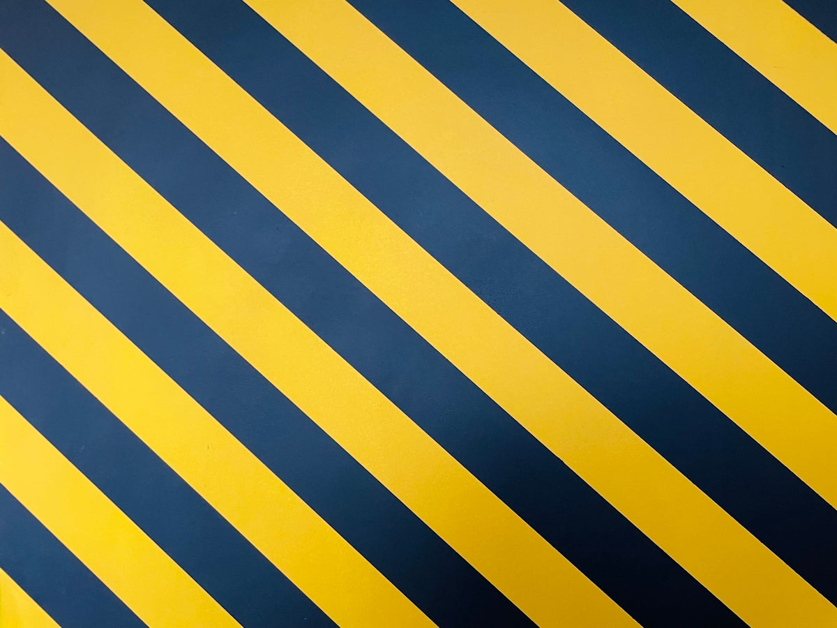 a black and yellow striped wallpaper with vertical stripes