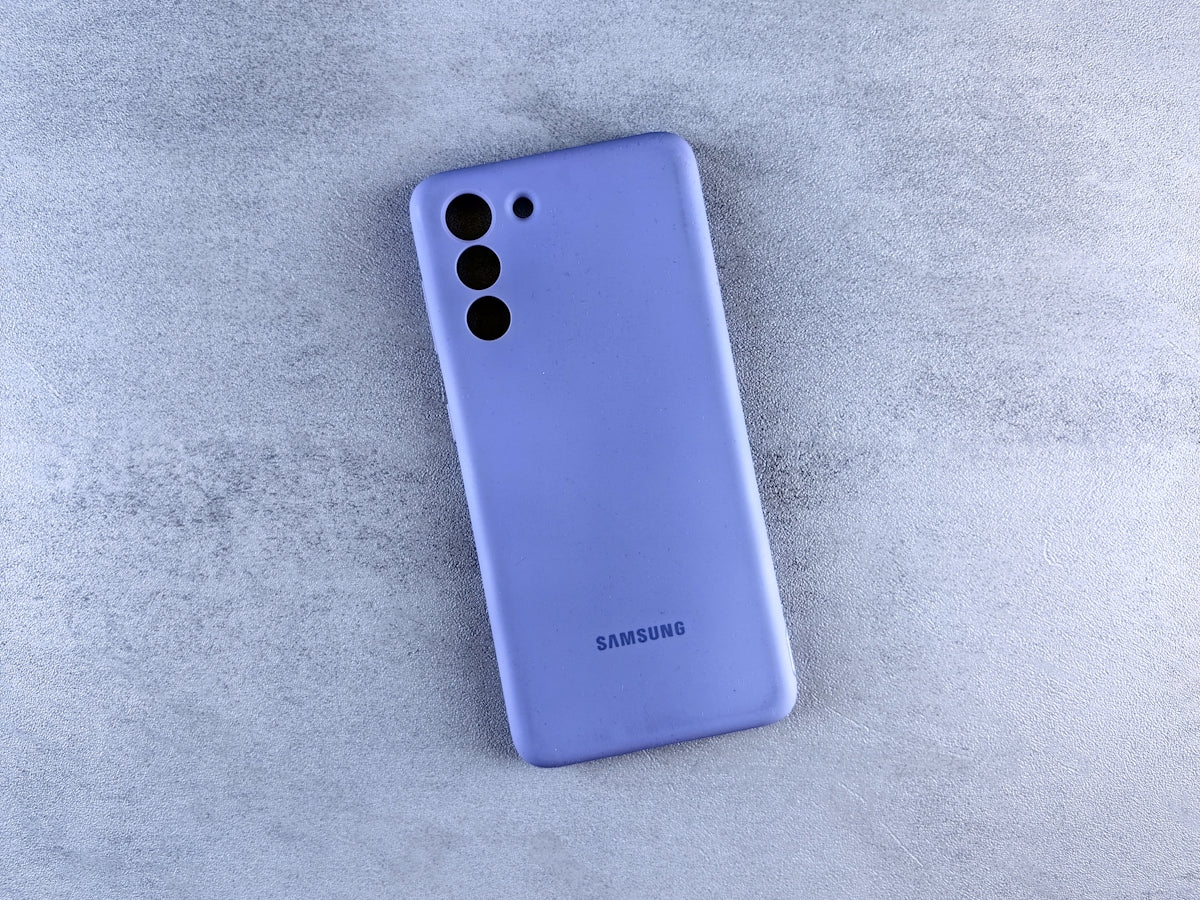 a blue samsung phone laying on a white surface